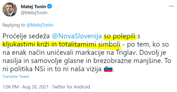 Tonin med odkrivanjem kljukastih križev na pročelju stavbe